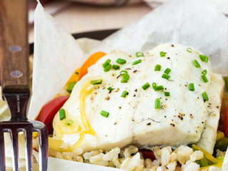 Fish and veggies baked in a foil packet in the oven makes for quick and easy clean-up. 